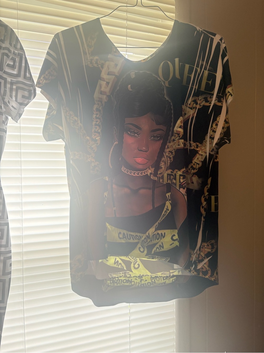 Black Graphic Tee with Gold Chain and Yellow Accent